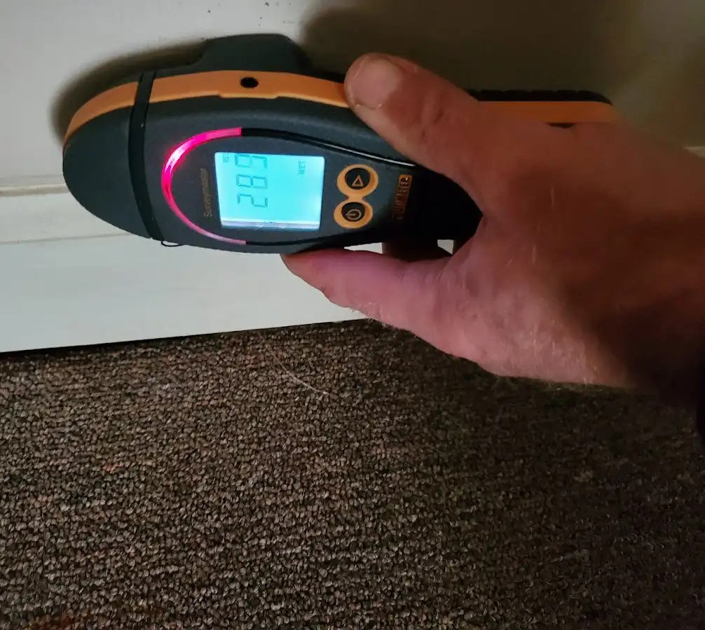 Moisture detection at baseboard during Storm Damage Restoration in Stanford